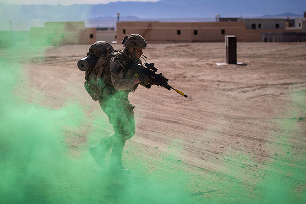 Royal Marine moving through smoke.