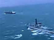 HMS Sutherland approaches the MV Nisha