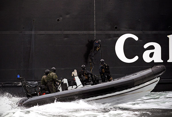 Marines boarding vessel from RIB